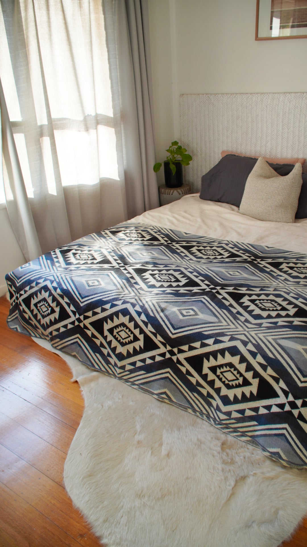 Teal alpaca throw blanket styled on a bed – artisan-made Ecuador, Andean Home Australia